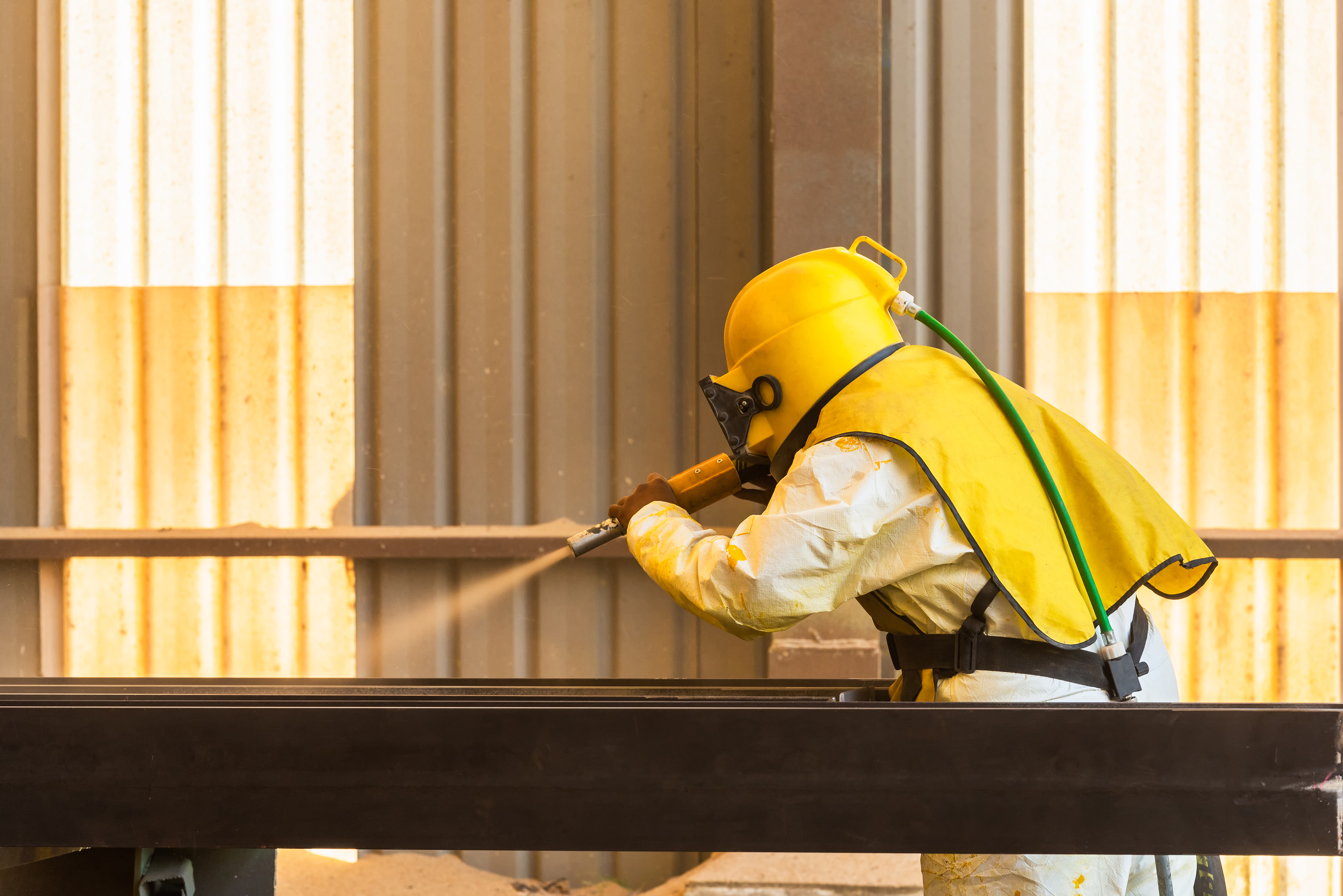 man blasting in yellow suit