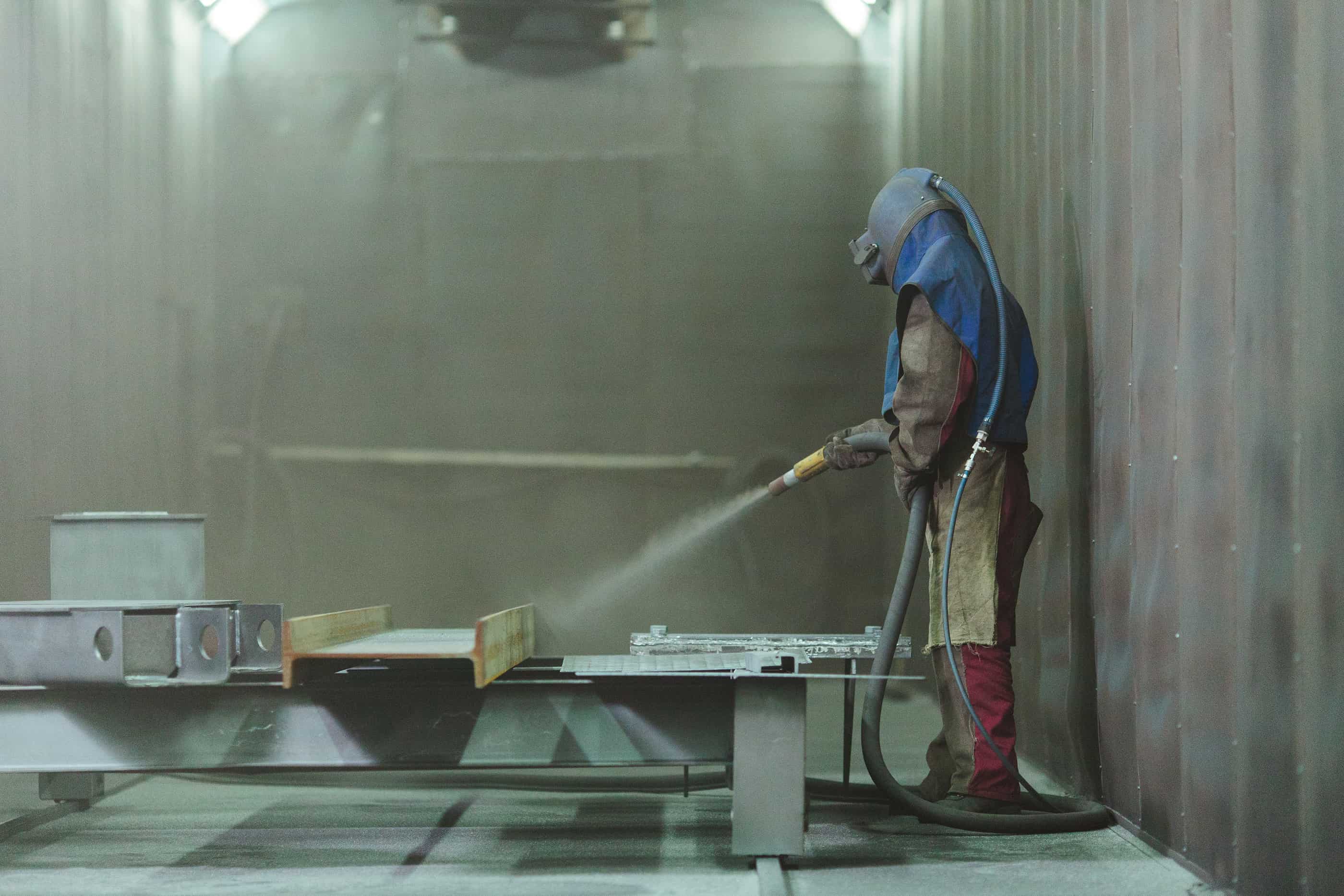 man blasting in blast room
