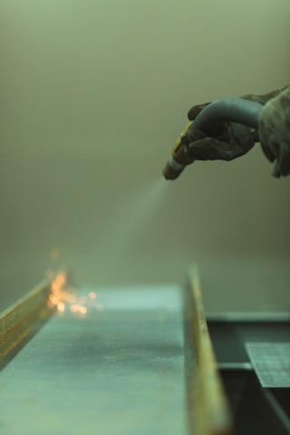 Abrasive blasting a metal surface during component surface preparation