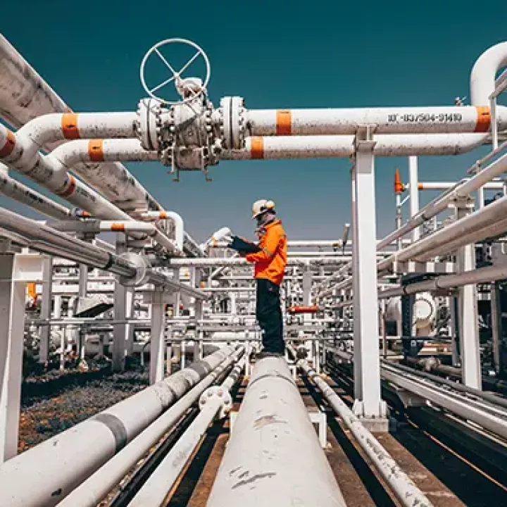 Oil and gas pipes are inspected at a refinery